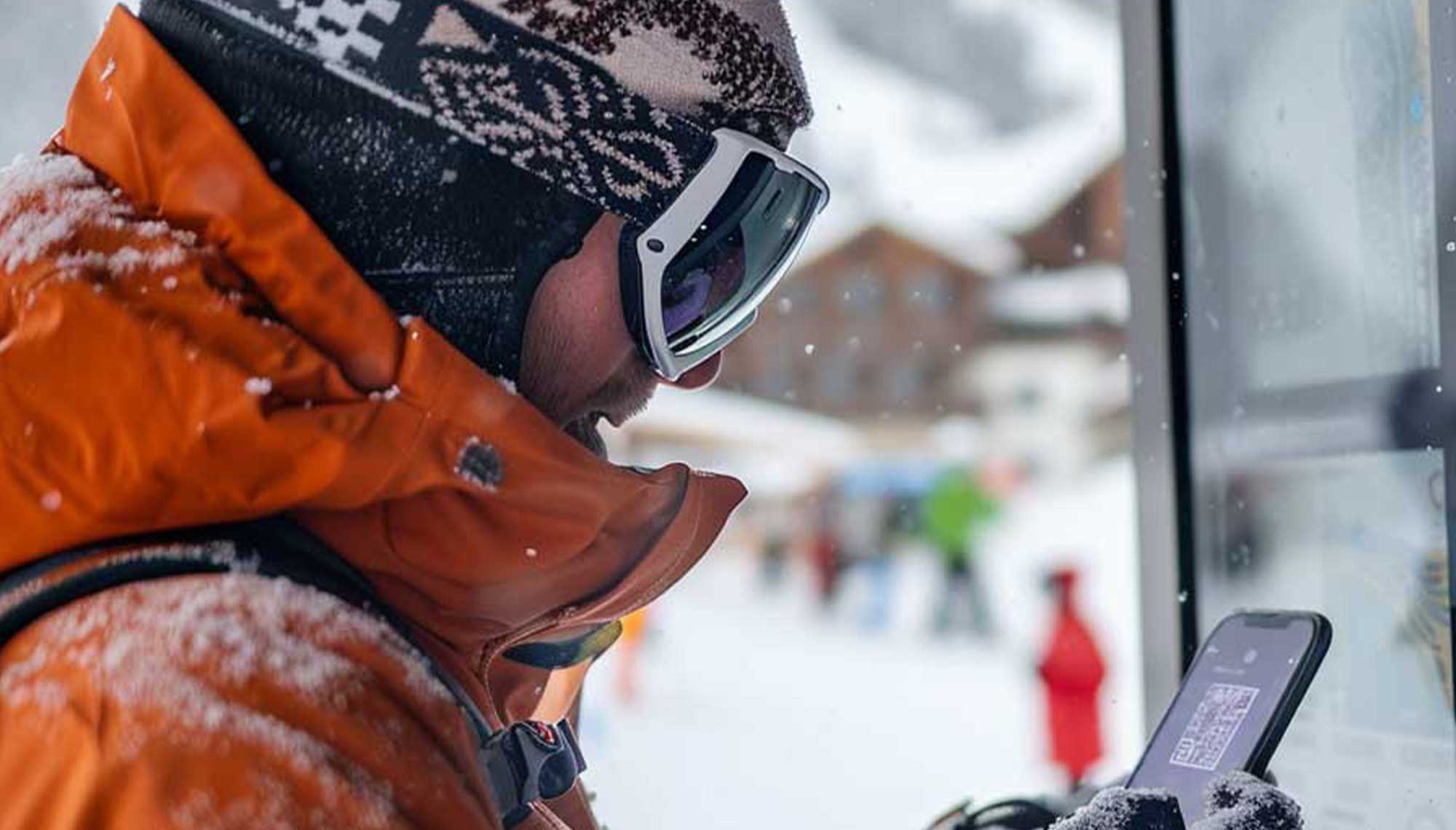 skier scanning a lift ticket at a snowy resort